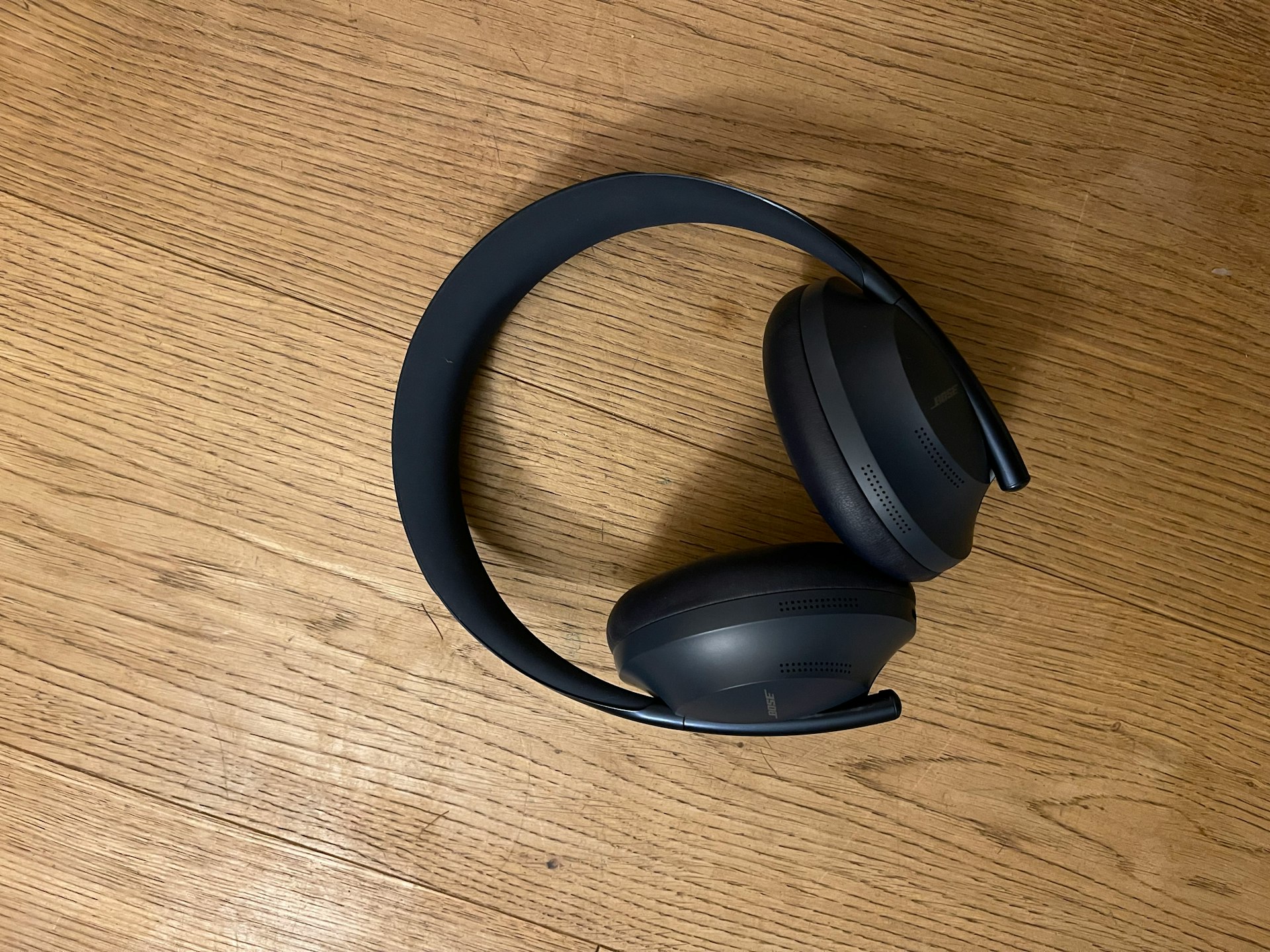 a pair of headphones sitting on top of a wooden table